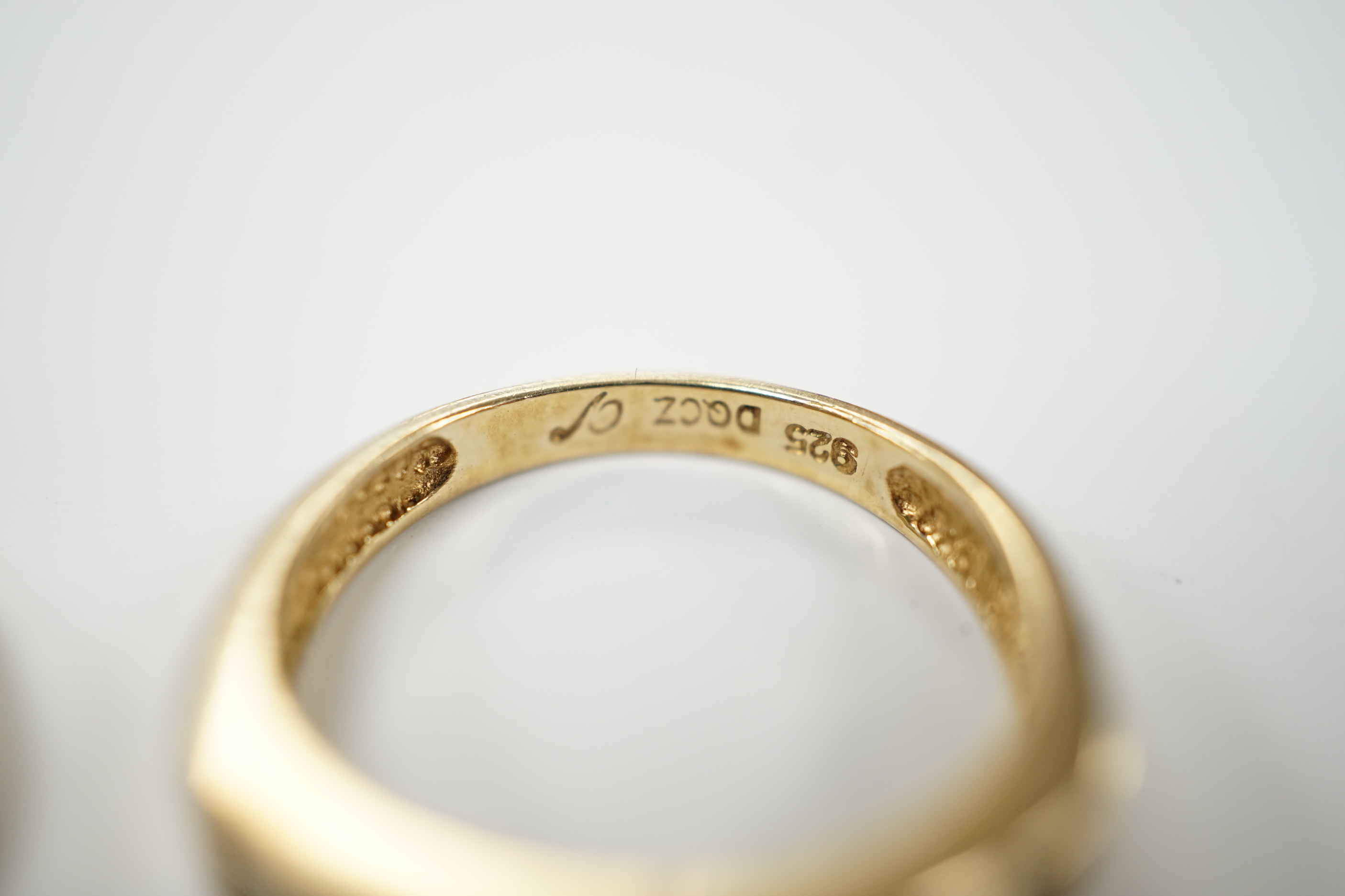 Two 9ct gold dress rings, one set with sapphire and diamonds, the other a single sapphire, and a diamond chip set ring, stamped 925, size M